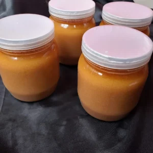 FreshPalli Danadar Ghee jars arranged on black fabric background